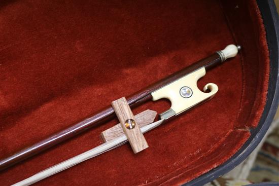 A silver mounted violin bow, an ivory mounted violin bow and a late 19th century German violin, cased